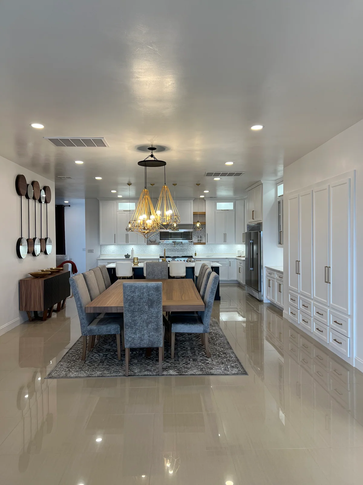 Black & Brass kitchen with white cabinetry, dark island, view 8