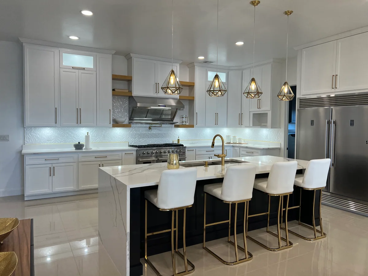 Black & Brass kitchen with white cabinetry, dark island, view 2