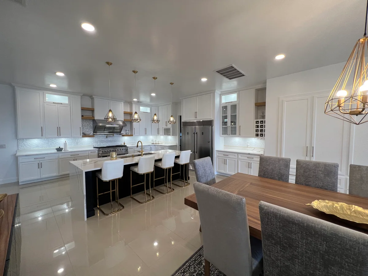 Black & Brass kitchen with white cabinetry, dark island, view 4