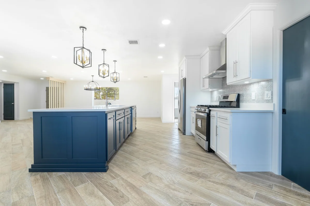 Blue Horizon kitchen with blue island, white cabinetry, view 2