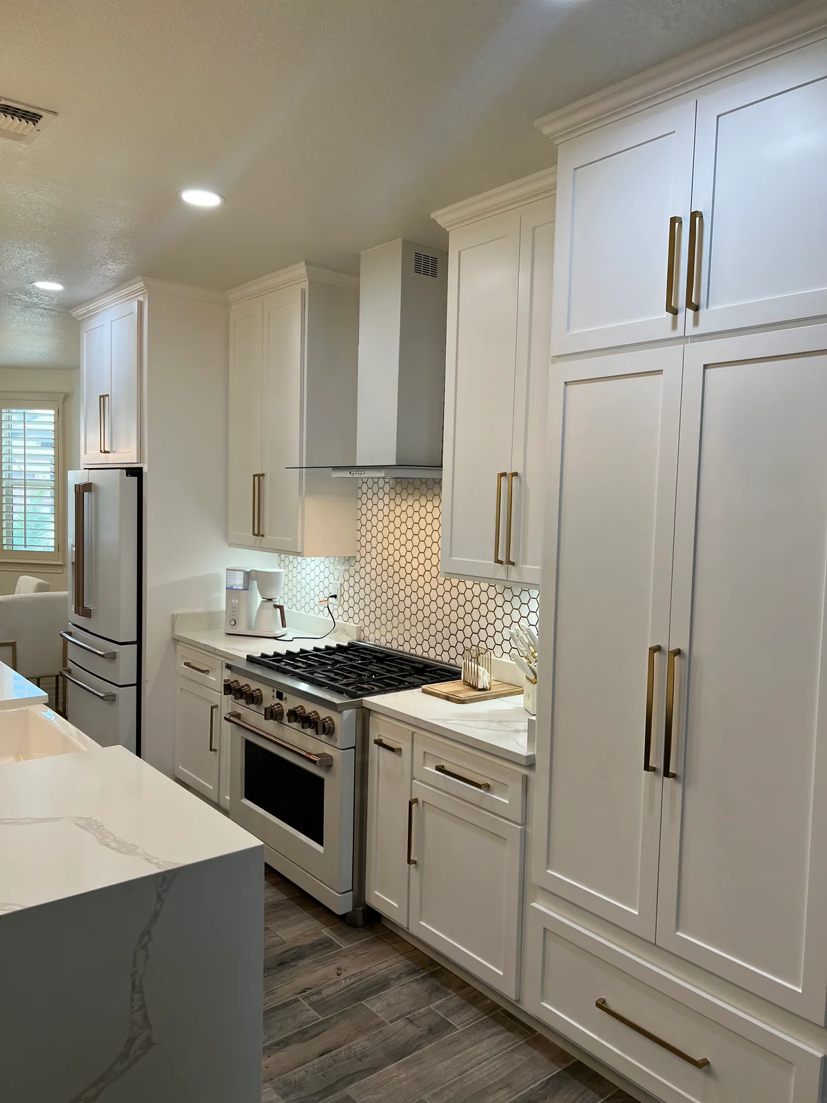 Clean Lines kitchen with light cabinetry, waterfall island, view 7