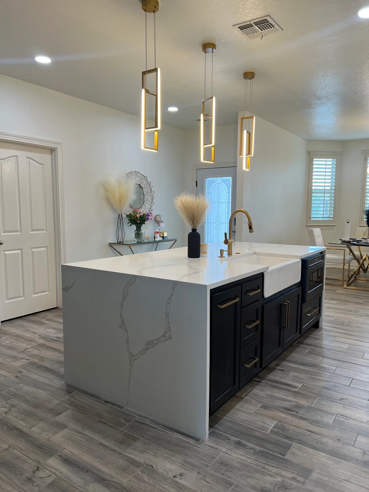 Clean Lines kitchen with light cabinetry, waterfall island, view 2