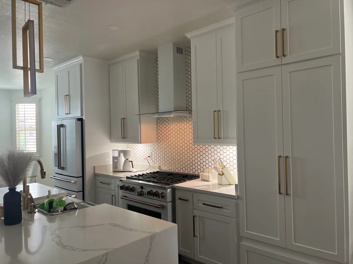 Clean Lines kitchen with light cabinetry, waterfall island, view 4