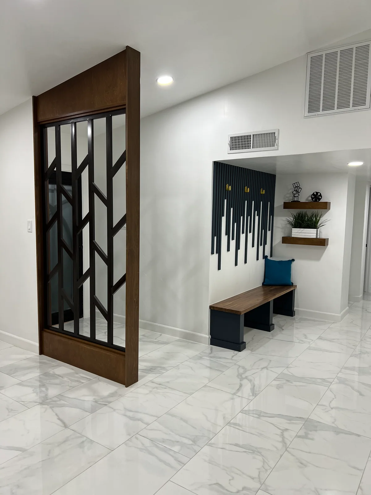 Wood entryway screen beside a built-in bench