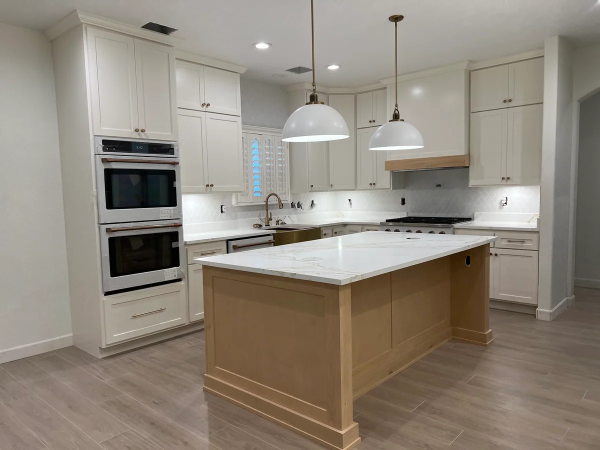 Natural Balance kitchen with white cabinetry, wood island, view 1