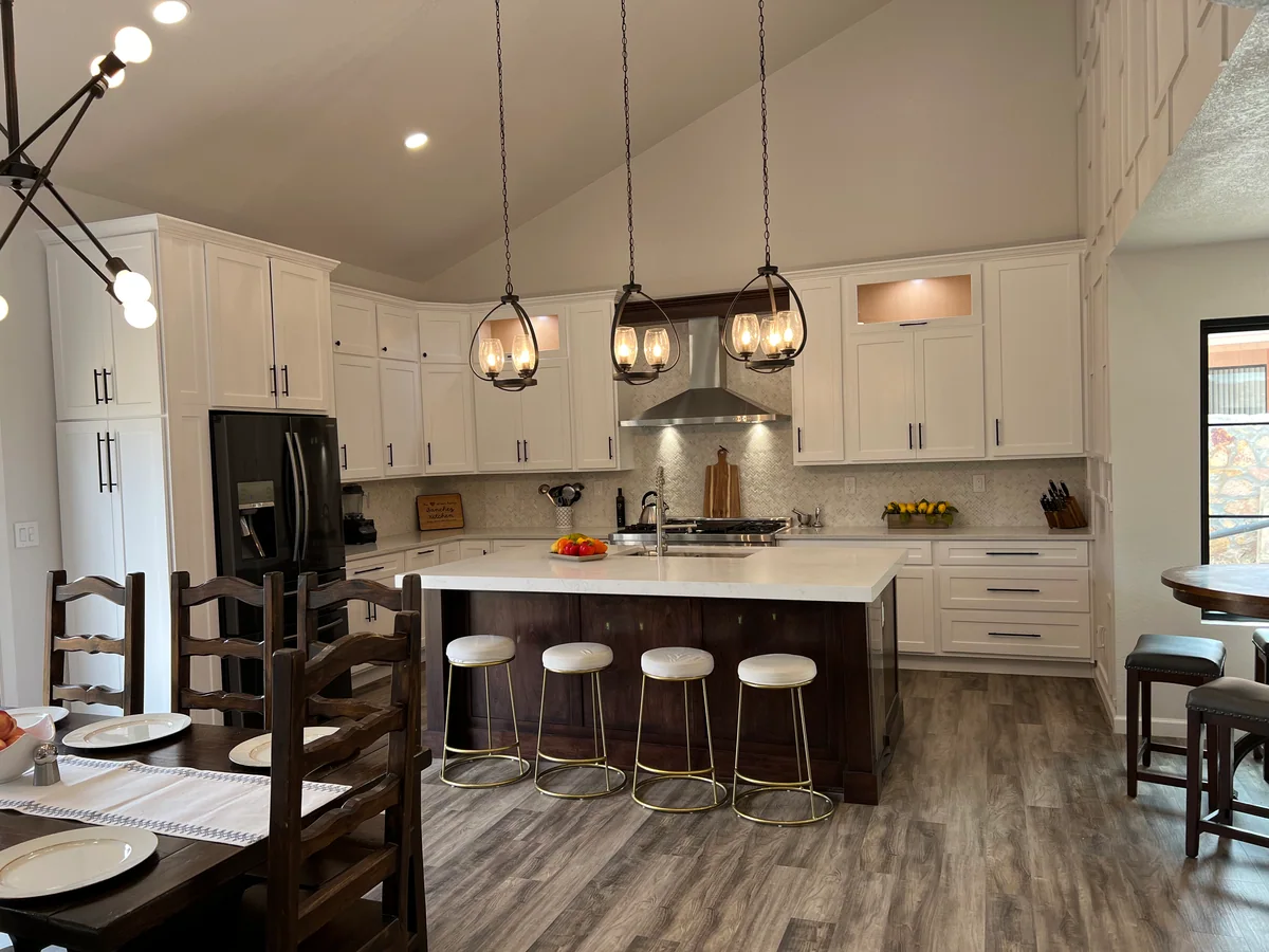 Open & Airy kitchen with white cabinetry, dark wood island, view 4
