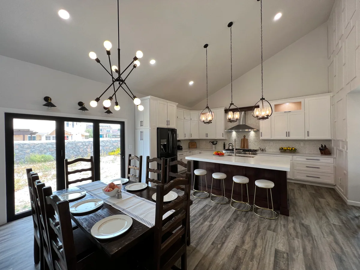 Open & Airy kitchen with white cabinetry, dark wood island, view 5