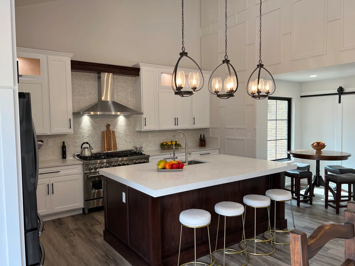 Open & Airy kitchen with white cabinetry, dark wood island, view 3