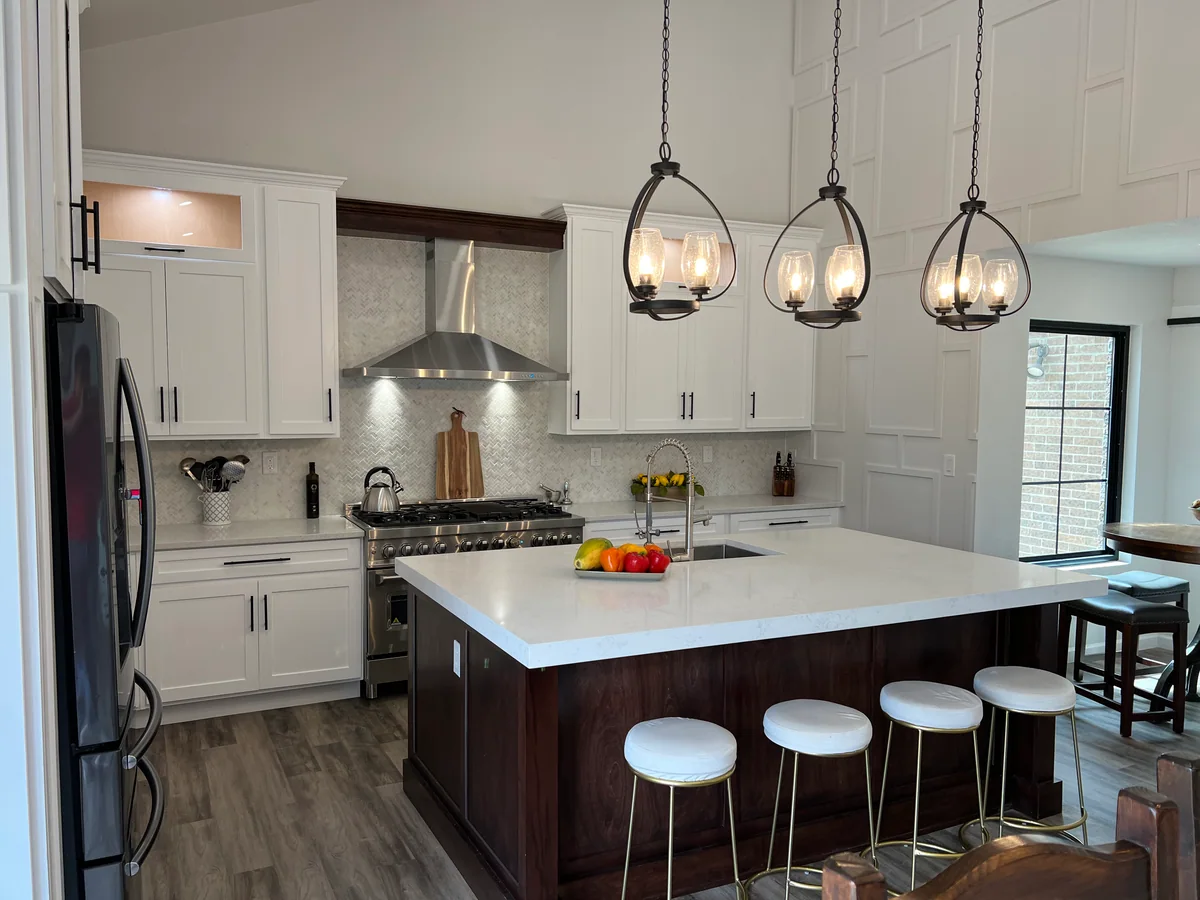 Open & Airy kitchen with white cabinetry, dark wood island, view 1