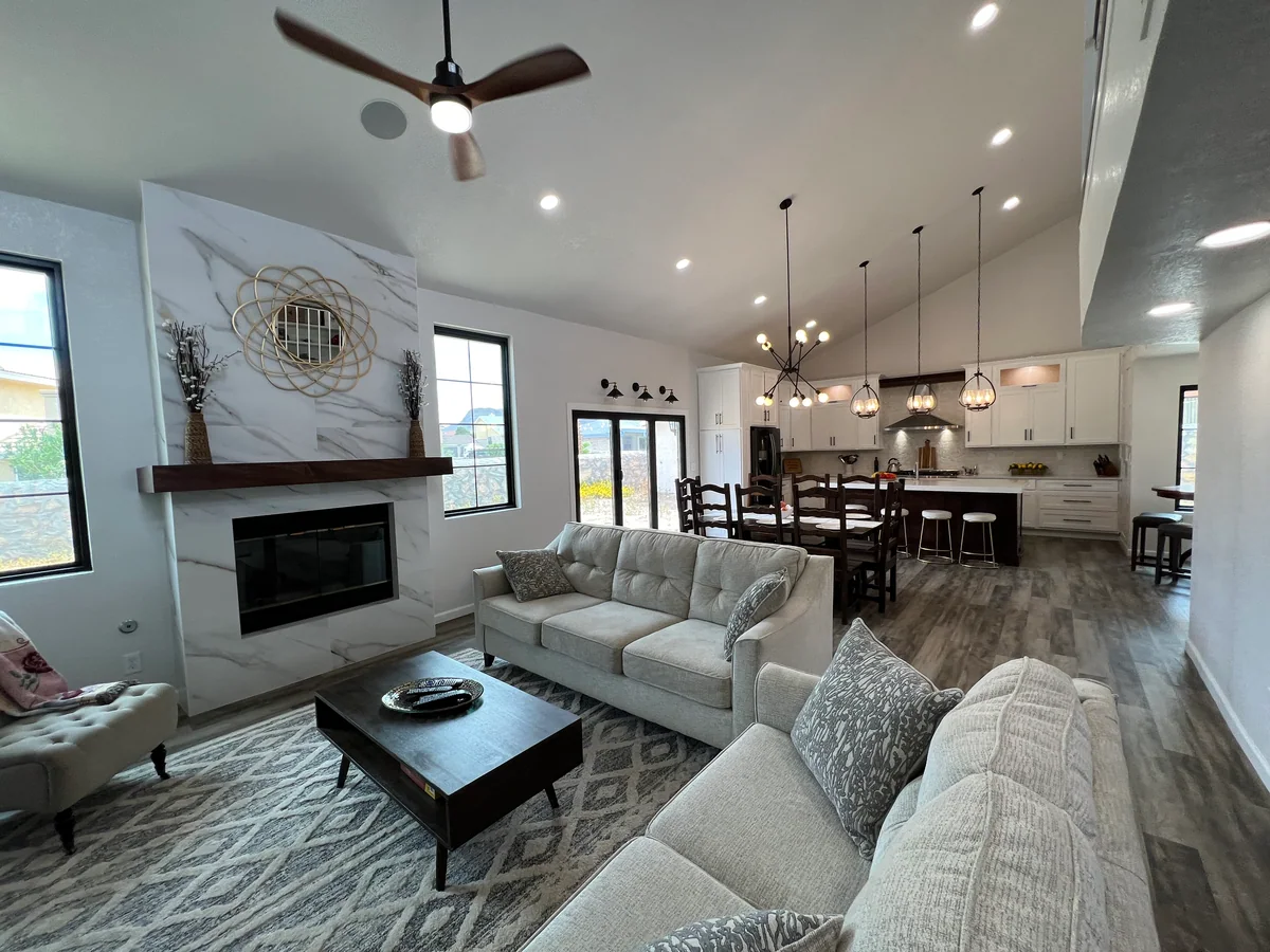 Open living area looking toward the white kitchen and dark island