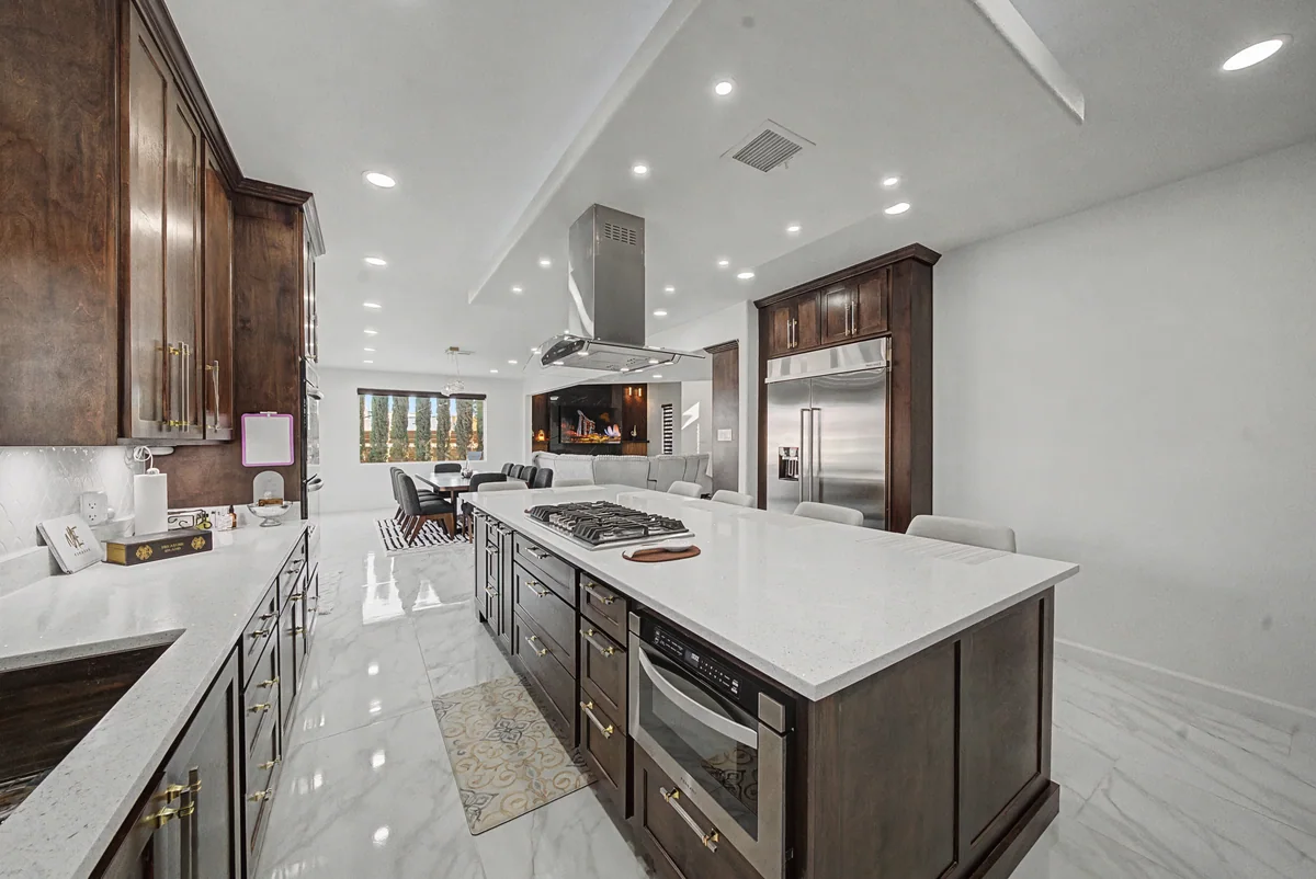 Warm Heritage kitchen with wood cabinetry, lighted glass cabinets, view 4