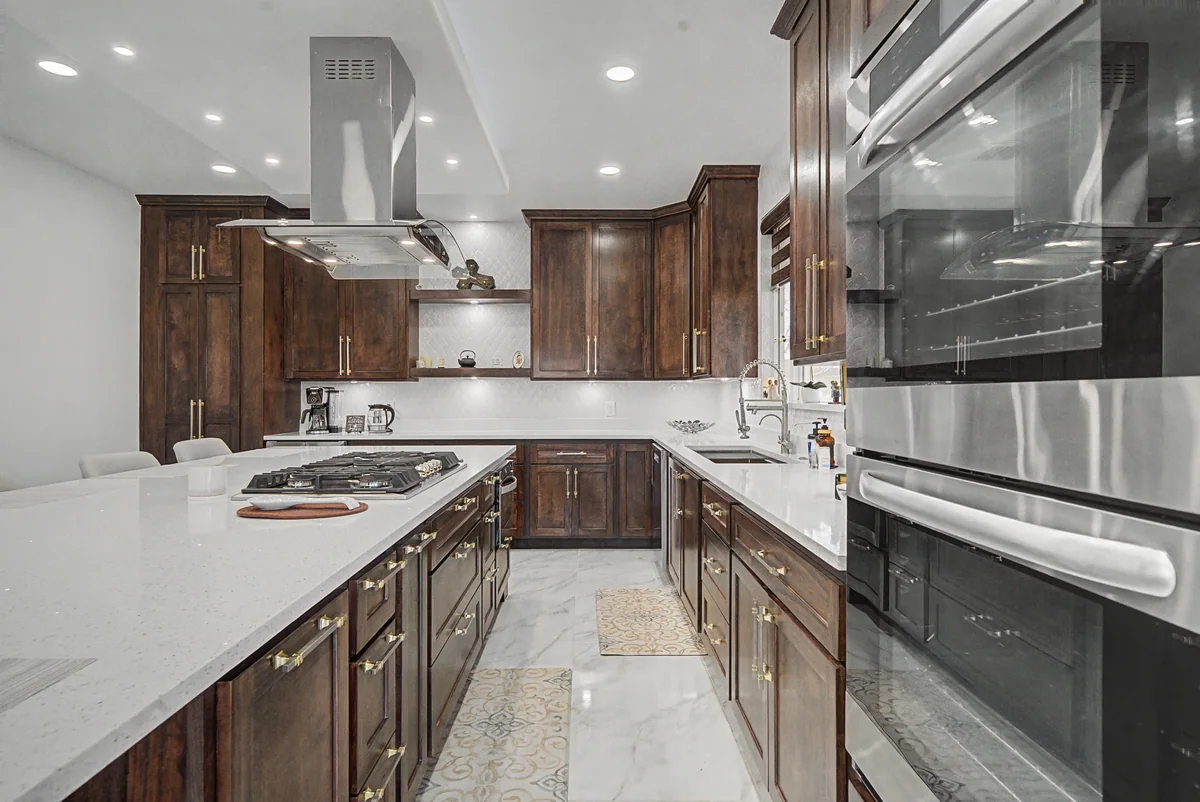 Warm Heritage kitchen with wood cabinetry, lighted glass cabinets, view 6