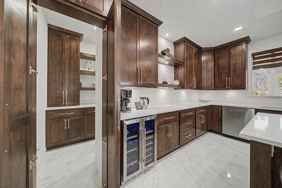 Wood pantry cabinetry with a beverage refrigerator