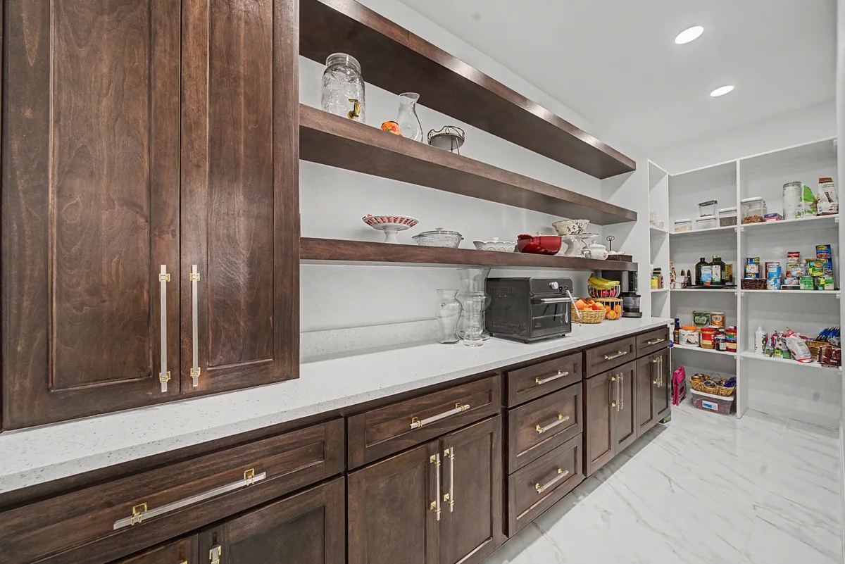 Custom wood cabinetry and open pantry shelves