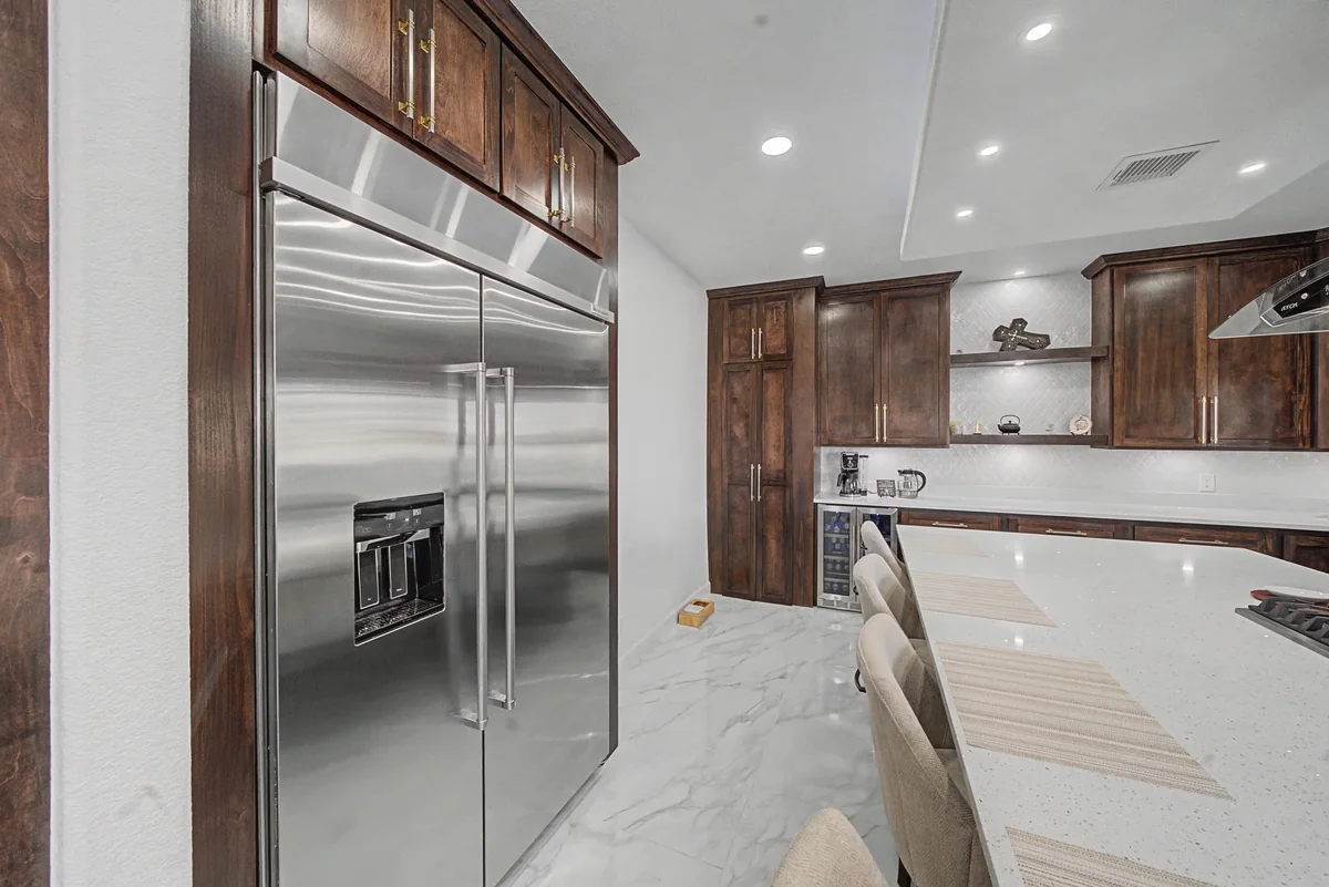 Warm Heritage kitchen with wood cabinetry, lighted glass cabinets, view 7