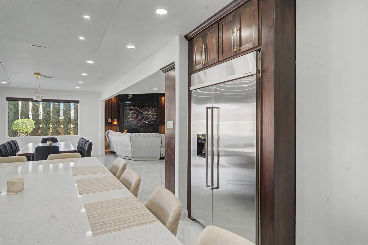 Warm Heritage kitchen with wood cabinetry, lighted glass cabinets, view 9